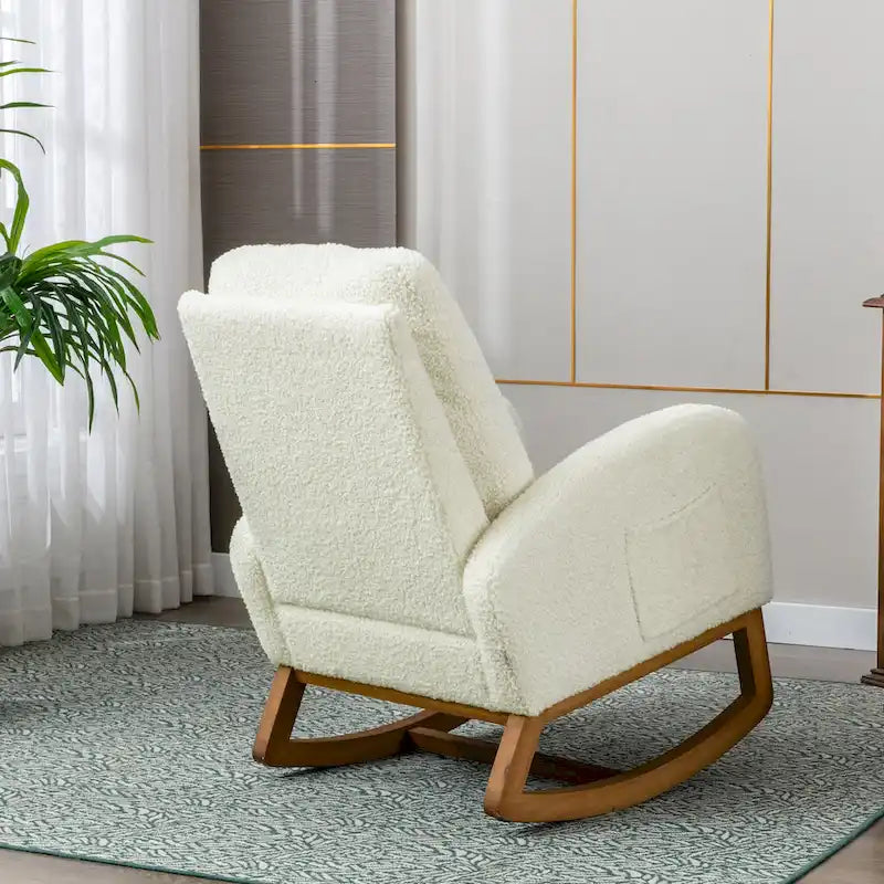 Fauteuil à bascule haut dossier en tissu Teddy crème, base en bois massif, poche latérale