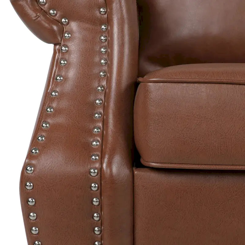 Fauteuil club en similicuir marron cognac avec cloutage et accoudoirs roulés